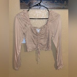 Tan long sleeve, rouched. Never worn with tags